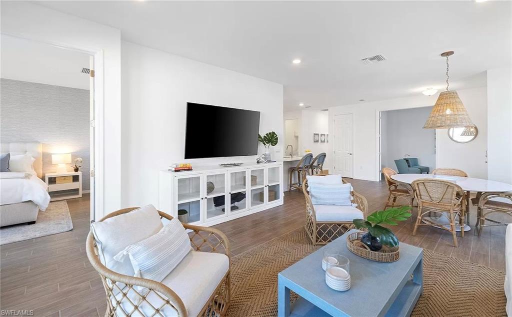1213 Enbrook Loop Naples, FL 34114 - Photo 9 of 24 a living room with furniture and a flat screen tv
