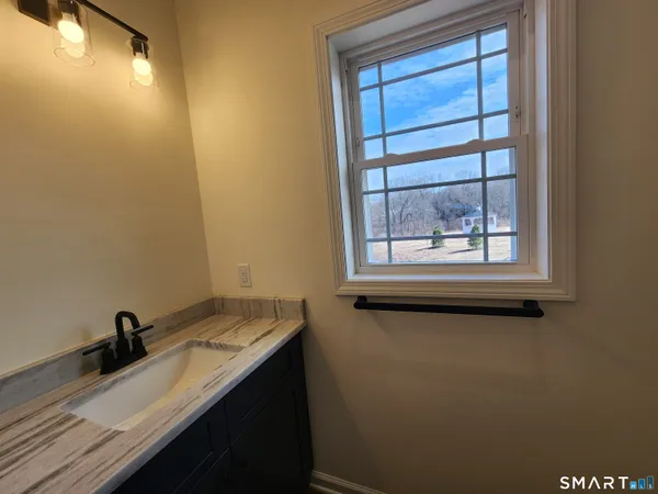 a bathroom with a sink and a window