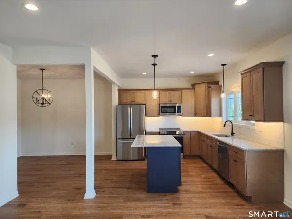 a large kitchen with a table and chairs