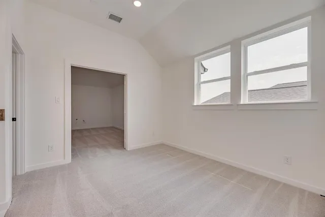 an empty room with windows and closet