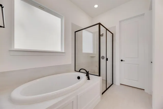a bathroom with a bathtub and a shower