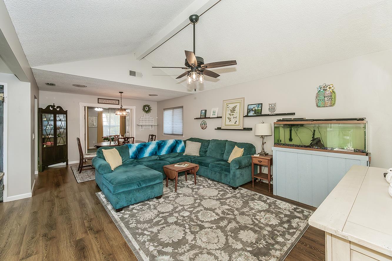 2820 Riverview Drive Madera, CA 93637 - Photo 16 of 60 a living room with kitchen island furniture and a wooden floor