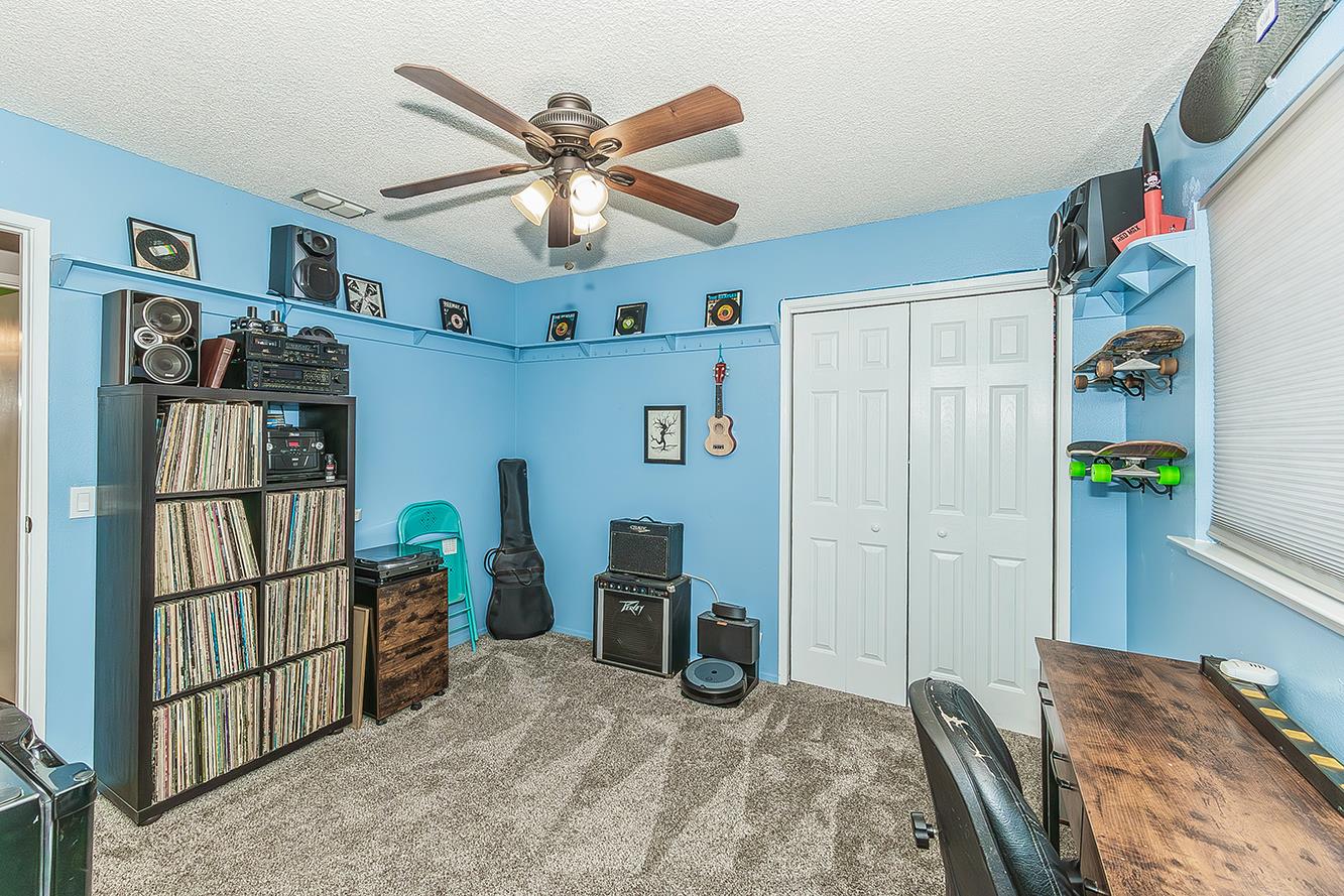 2820 Riverview Drive Madera, CA 93637 - Photo 33 of 60 a bedroom with a bed and a chandelier