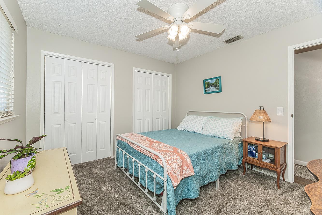 2820 Riverview Drive Madera, CA 93637 - Photo 36 of 60 a bedroom with a bed a chandelier and a dresser