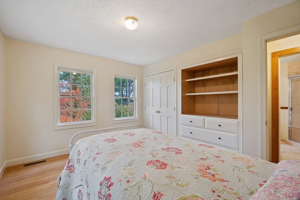 68 Frost Road Tyngsborough, MA 01879 - Photo 20 of 37 a bedroom with a bed and a flat screen tv