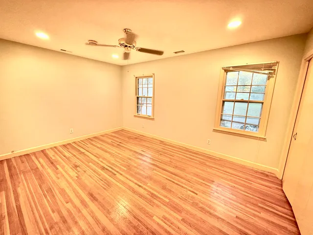 a view of a room with a wooden floor and a window