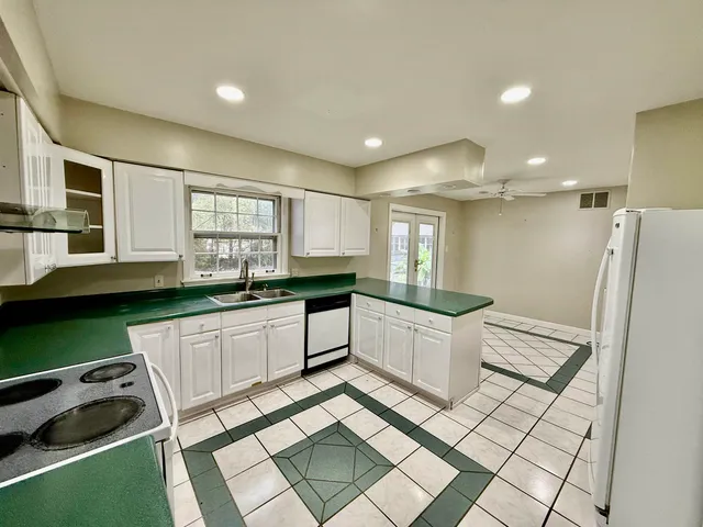 a view of a room with wooden floor and ceiling fan