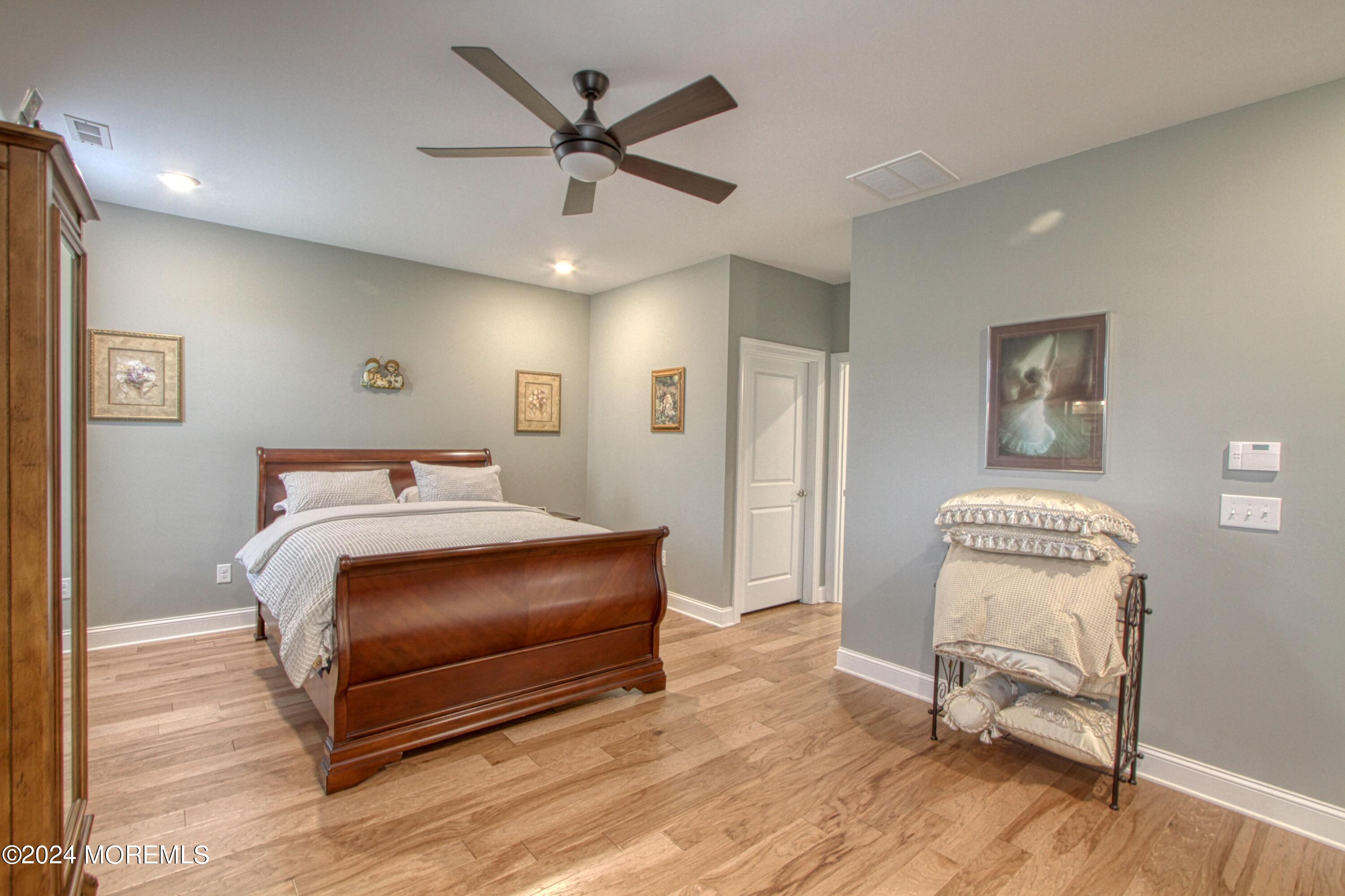 39 Butler Drive Barnegat, NJ 08005 - Photo 17 of 62 a bedroom with a bed and a chair