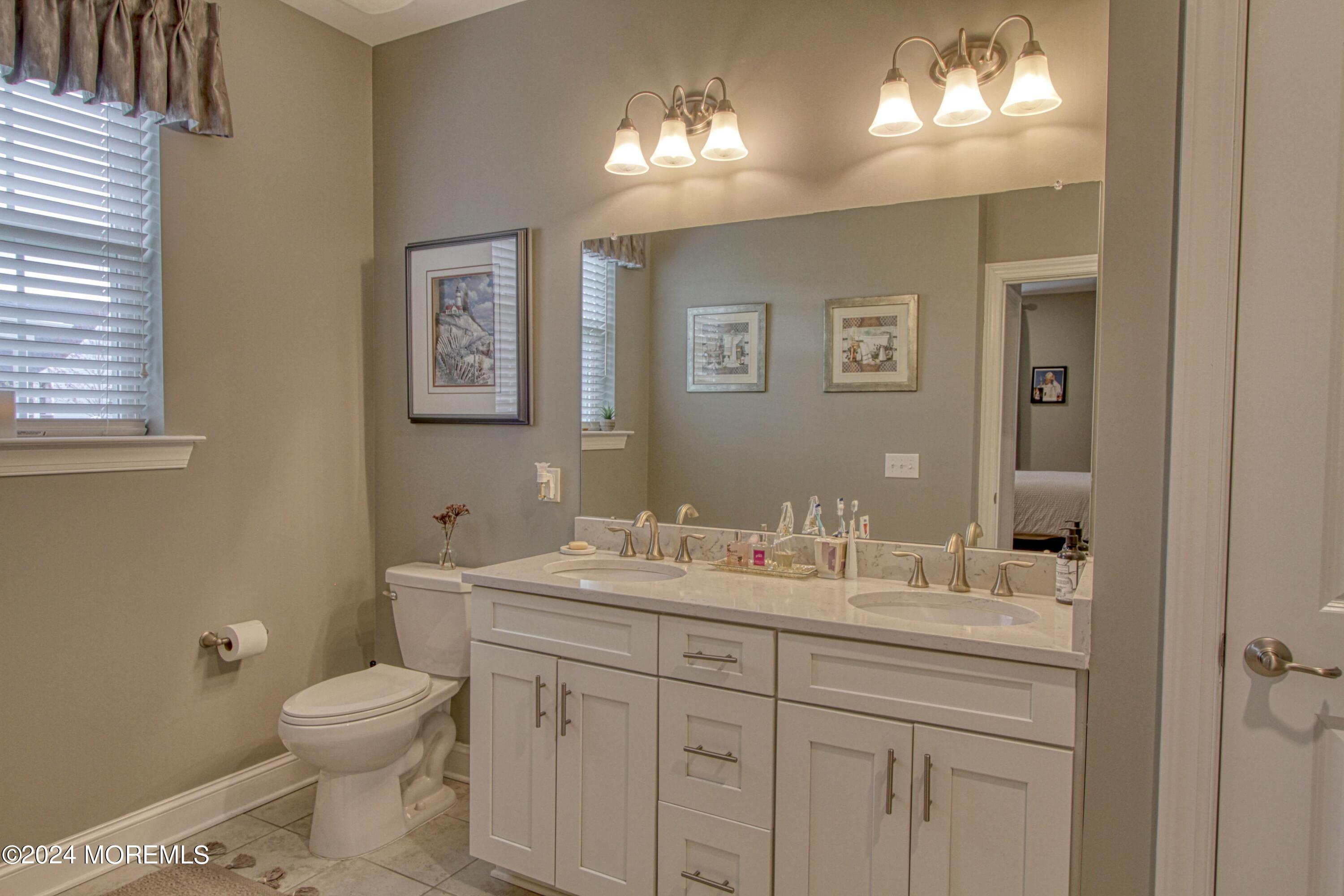 39 Butler Drive Barnegat, NJ 08005 - Photo 18 of 62 a bathroom with a toilet sink and mirror