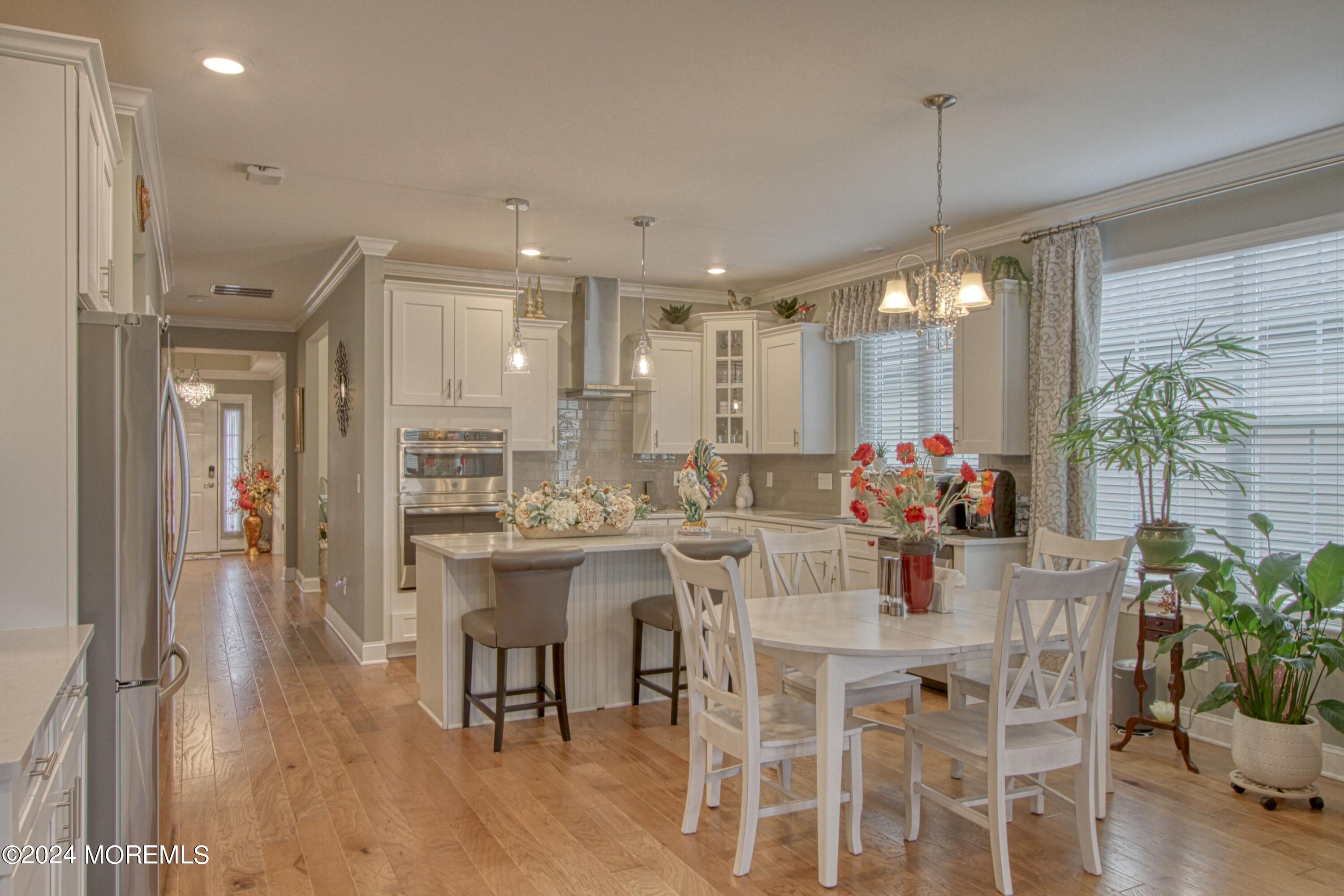 39 Butler Drive Barnegat, NJ 08005 - Photo 2 of 62 a kitchen with a dining table chairs and white cabinets