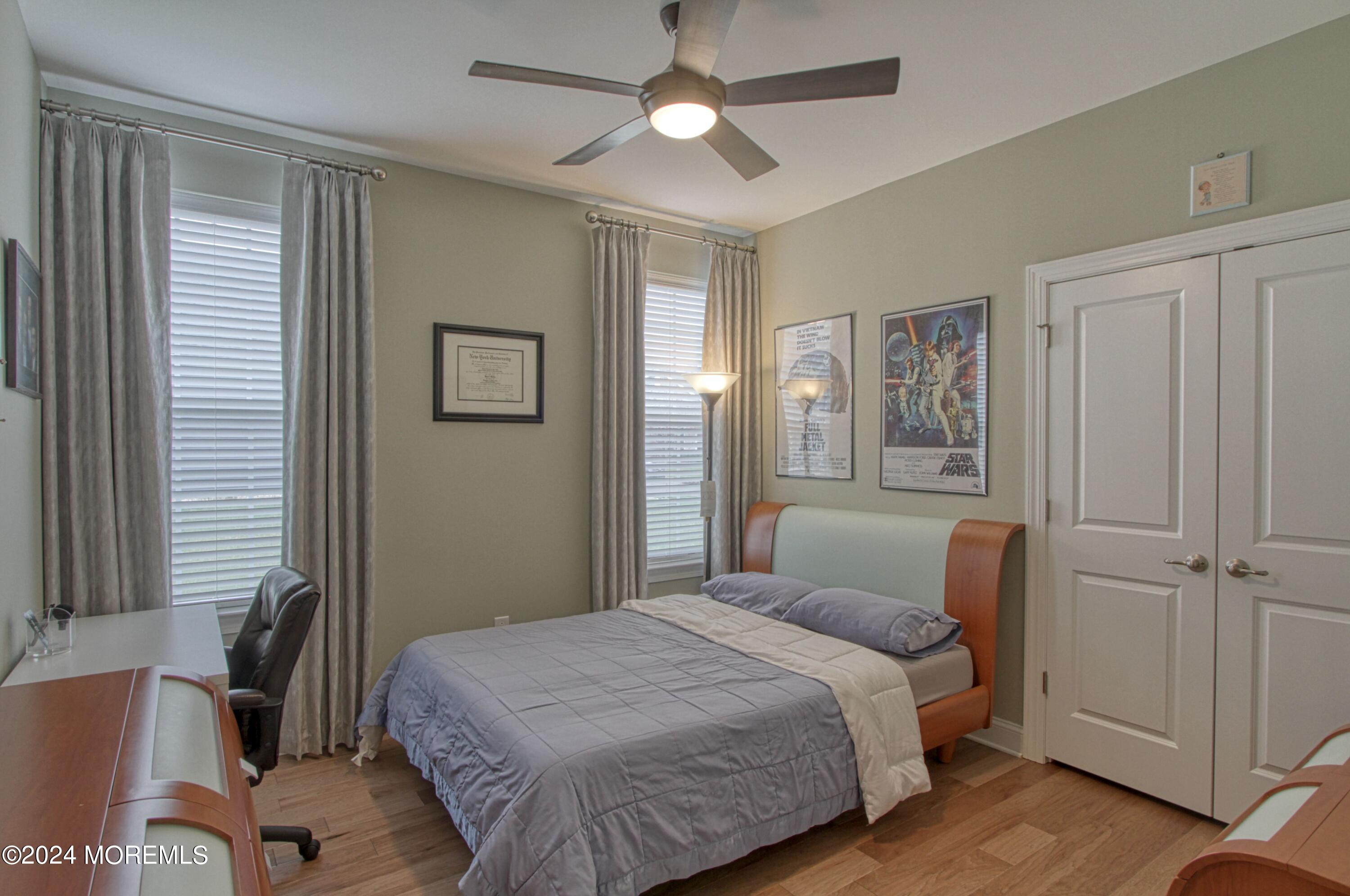39 Butler Drive Barnegat, NJ 08005 - Photo 21 of 62 a bedroom with a bed and a chandelier
