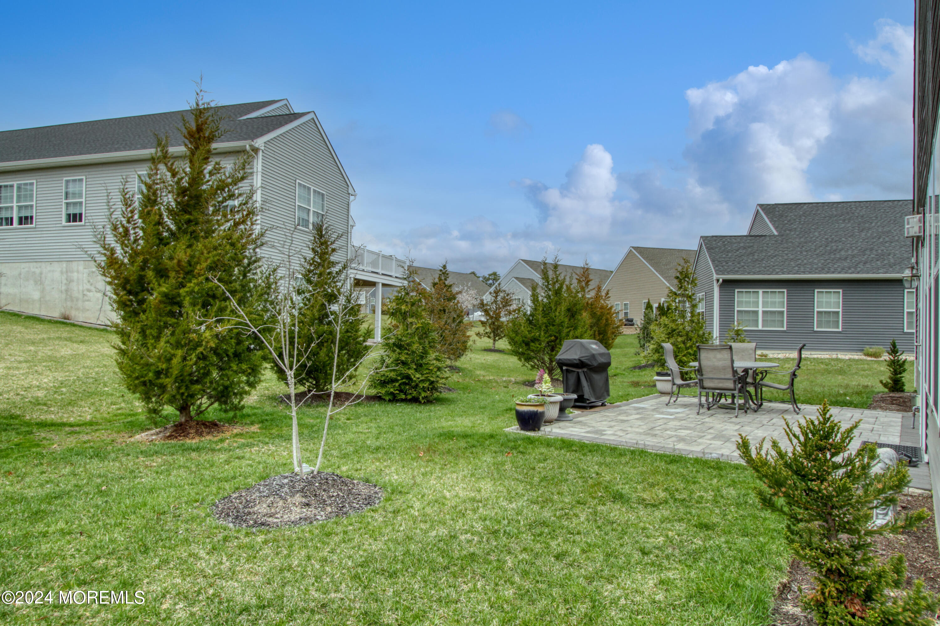 39 Butler Drive Barnegat, NJ 08005 - Photo 27 of 62 a view of a chair and table in backyard of the house