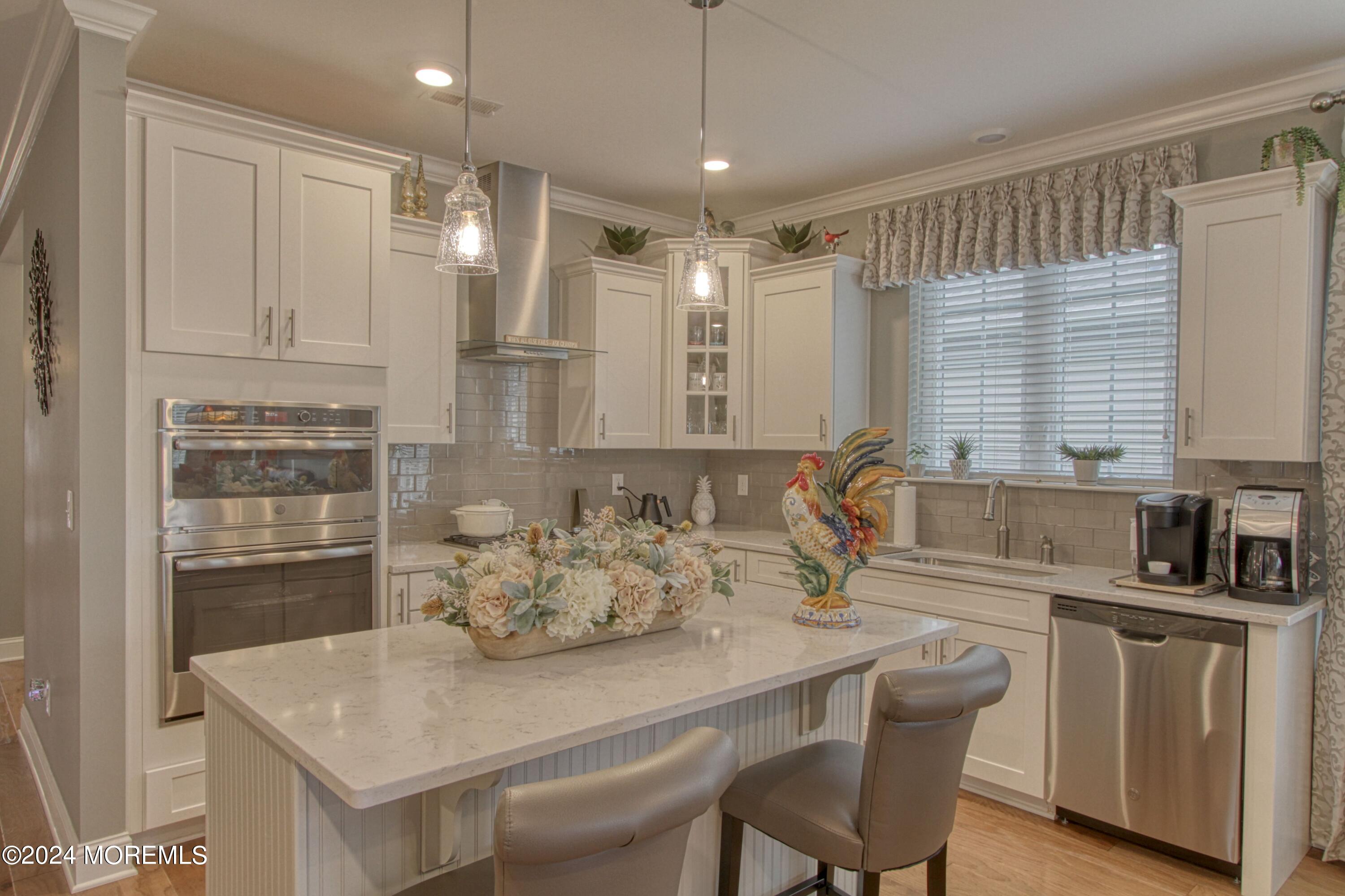 39 Butler Drive Barnegat, NJ 08005 - Photo 4 of 62 a kitchen with stainless steel appliances granite countertop a sink a stove a refrigerator cabinets and dining table