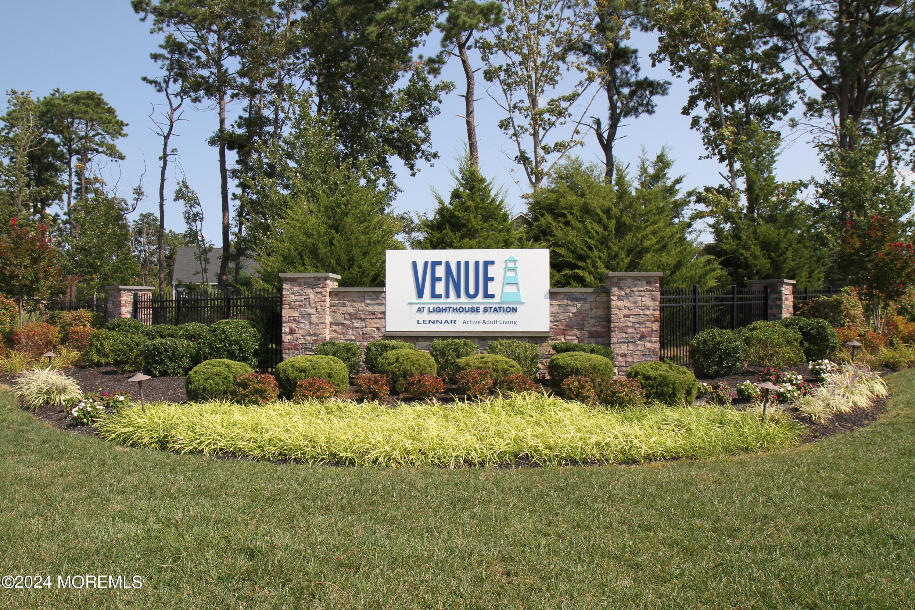 39 Butler Drive Barnegat, NJ 08005 - Photo 43 of 62 a sign that is sitting in the grass next to a building