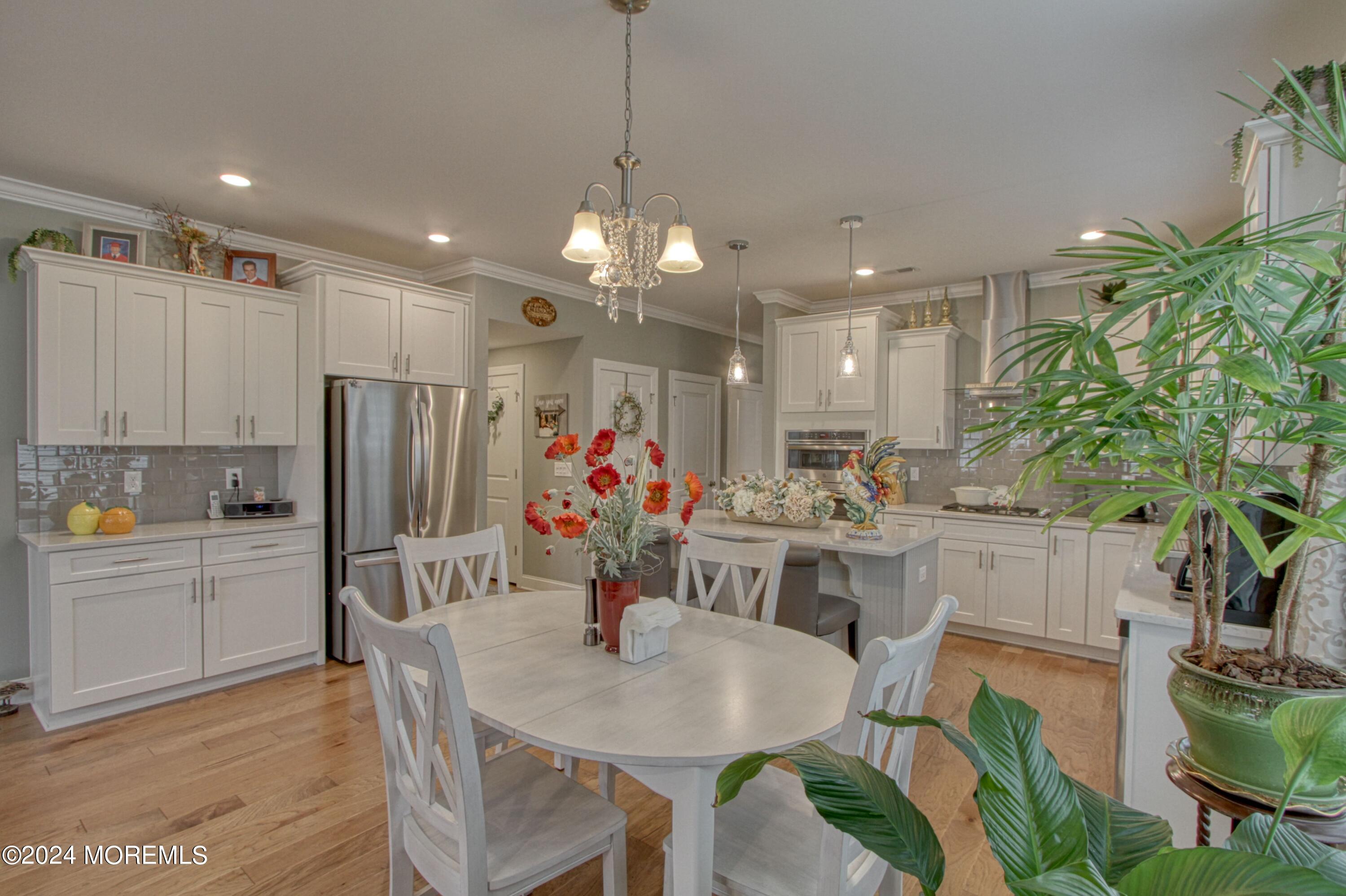 39 Butler Drive Barnegat, NJ 08005 - Photo 5 of 62 a view of a dining room and livingroom with furniture wooden floor a chandelier