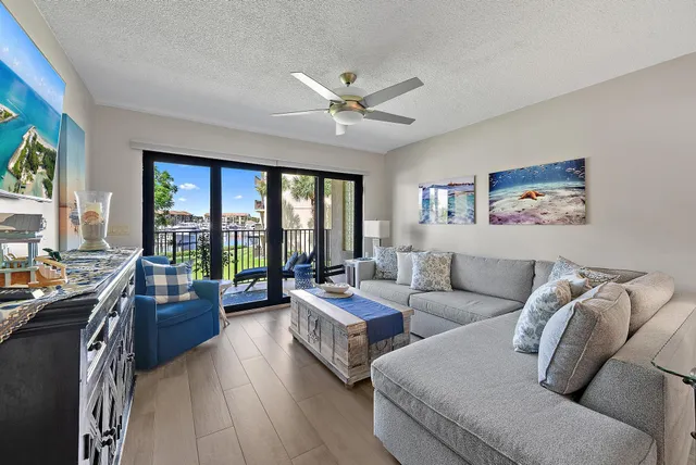 a living room with furniture and large windows
