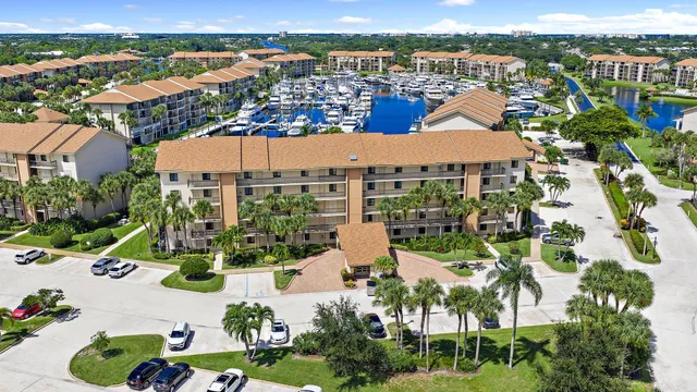 an aerial view of residential houses with outdoor space and ocean view