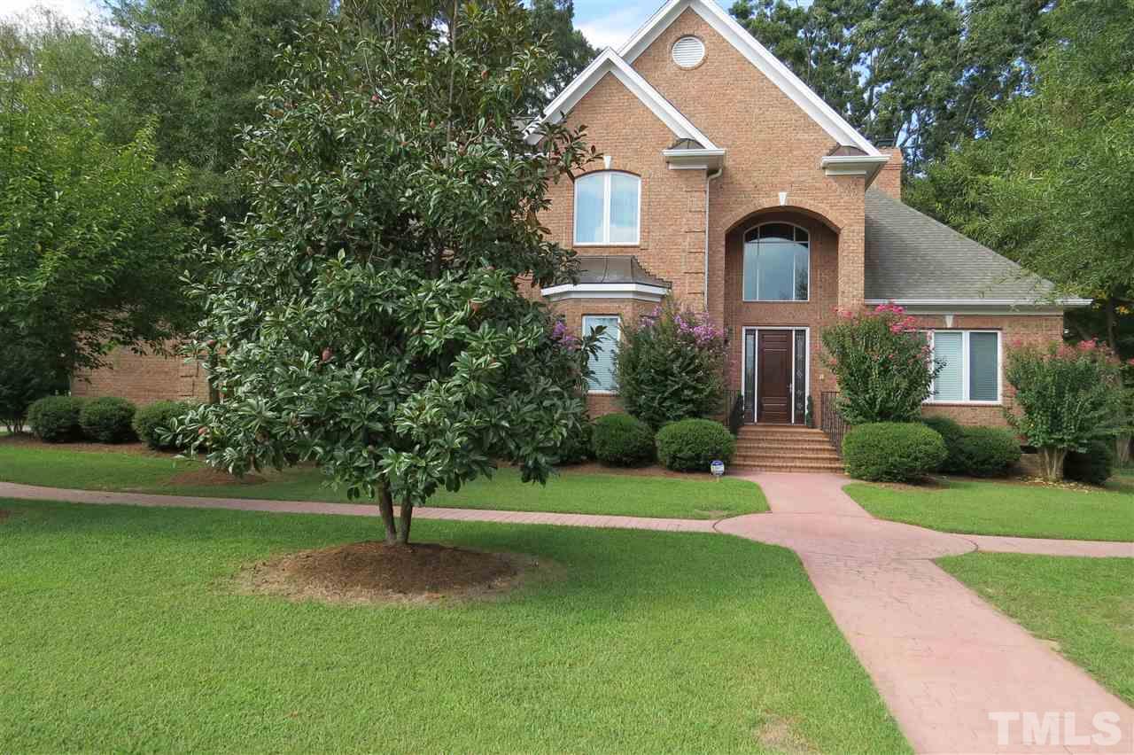 4008 Ovid Lane Raleigh, NC 27613 - Photo 1 of 25 a front view of a house with a yard and trees