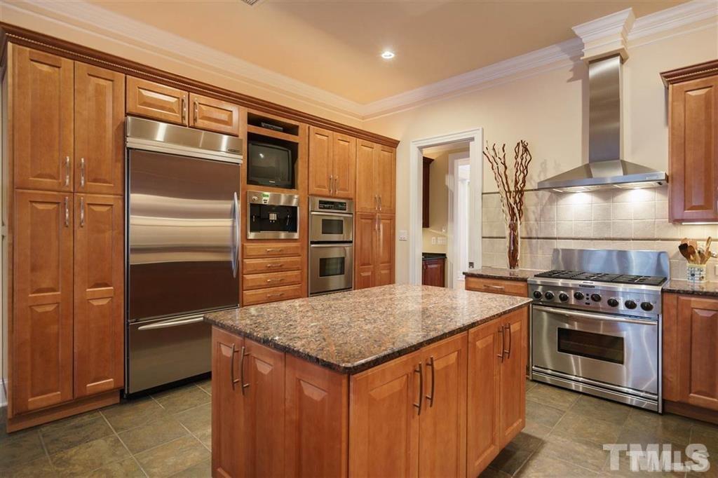 4008 Ovid Lane Raleigh, NC 27613 - Photo 11 of 25 a kitchen with a stove and a refrigerator