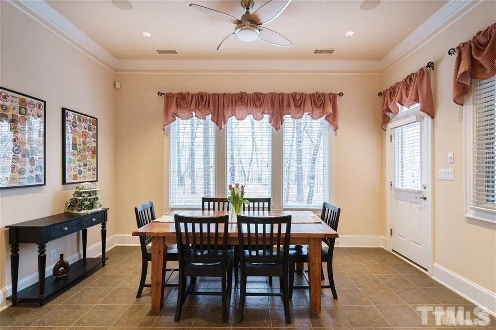 4008 Ovid Lane Raleigh, NC 27613 - Photo 12 of 25 a view of a a dining room with furniture window and wooden floor