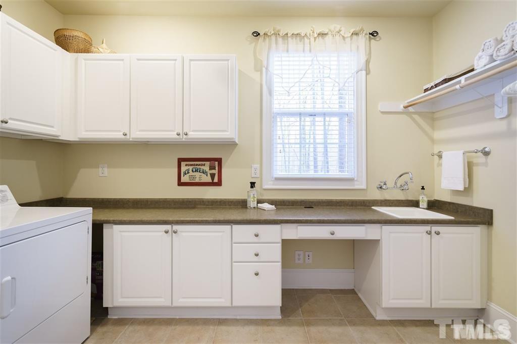 4008 Ovid Lane Raleigh, NC 27613 - Photo 13 of 25 a kitchen with granite countertop white cabinets and a sink