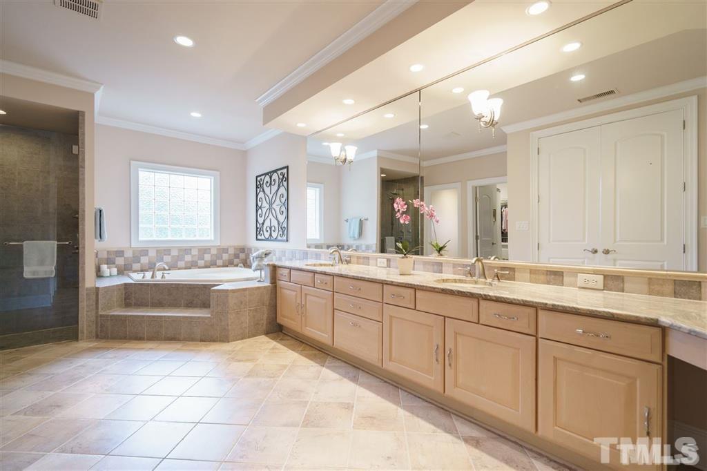 4008 Ovid Lane Raleigh, NC 27613 - Photo 16 of 25 a large bathroom with a large tub sink and toilet