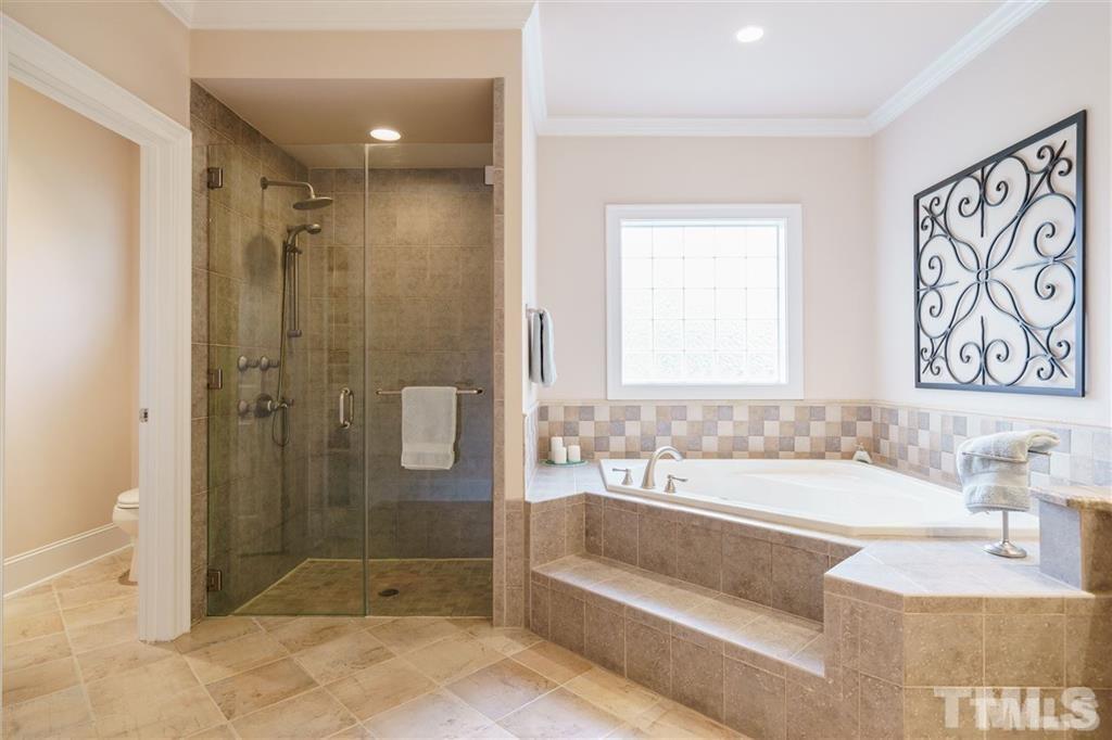 4008 Ovid Lane Raleigh, NC 27613 - Photo 17 of 25 a bathroom with a bathtub and a shower