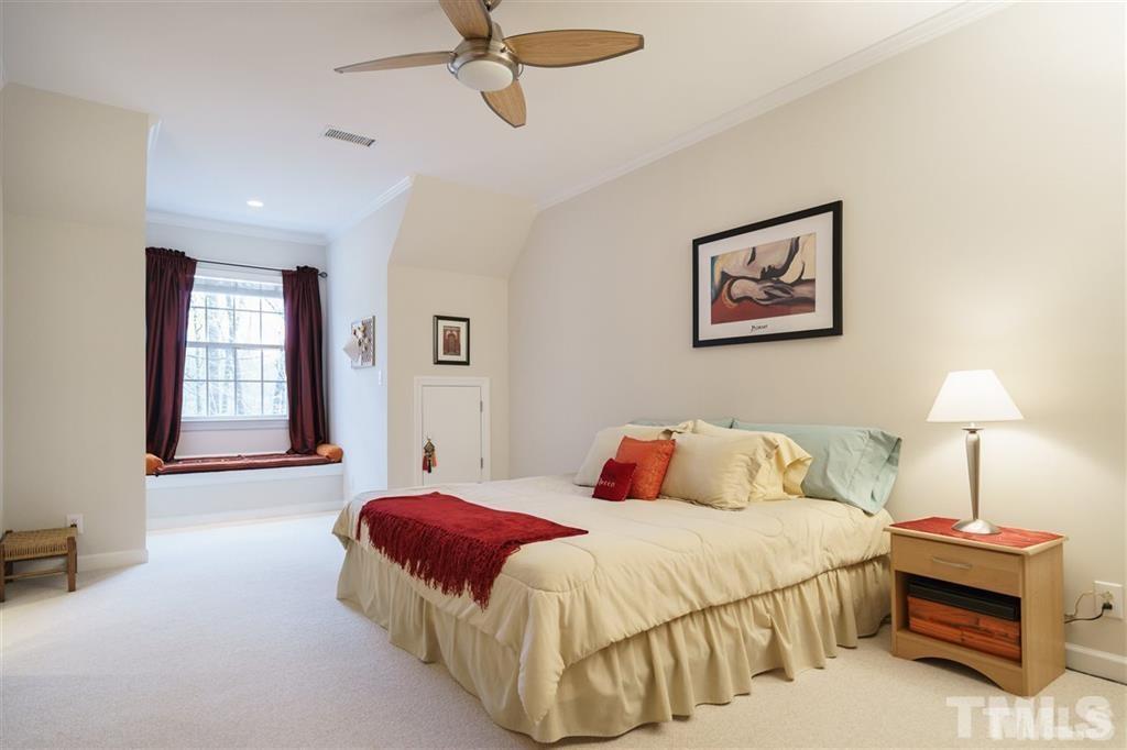 4008 Ovid Lane Raleigh, NC 27613 - Photo 20 of 25 a bedroom with a bed and a lamp
