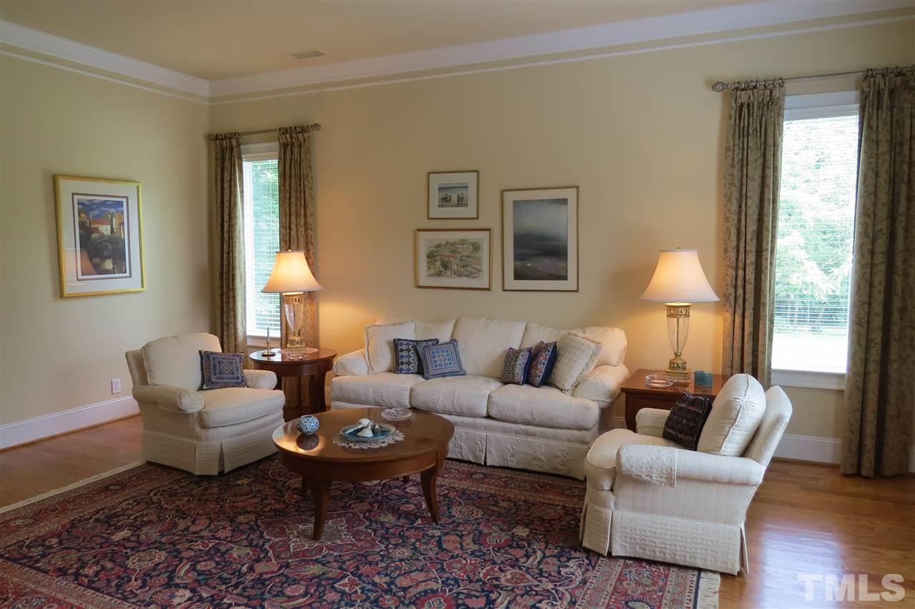 4008 Ovid Lane Raleigh, NC 27613 - Photo 2 of 25 a living room with furniture a lamp and a large window