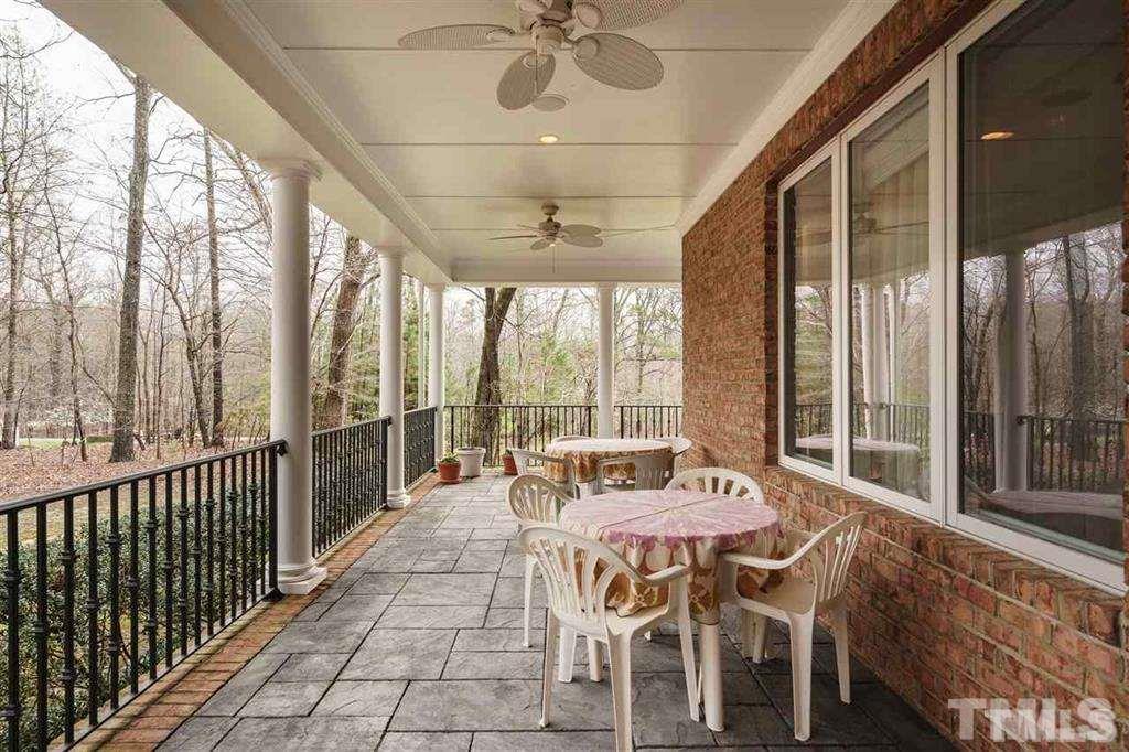 4008 Ovid Lane Raleigh, NC 27613 - Photo 22 of 25 a dining room with furniture water view and a floor to ceiling window