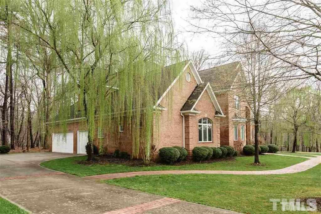 4008 Ovid Lane Raleigh, NC 27613 - Photo 23 of 25 a front view of a house with a yard and trees