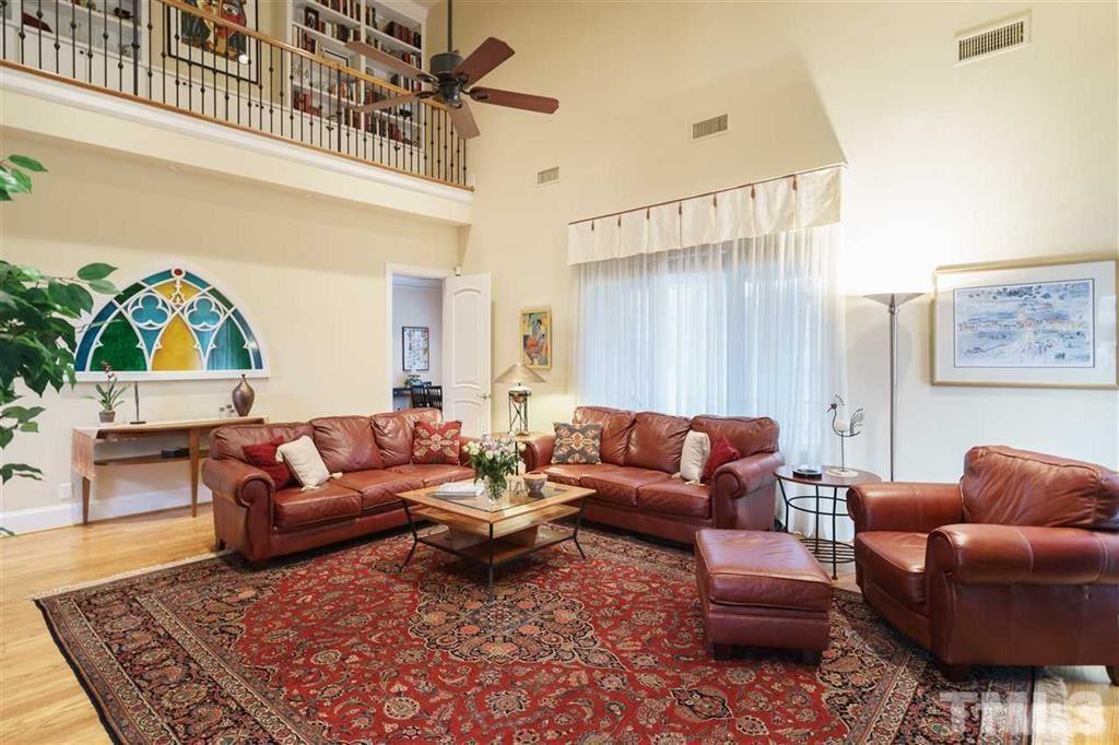 4008 Ovid Lane Raleigh, NC 27613 - Photo 9 of 25 a living room with furniture ceiling fan and a rug