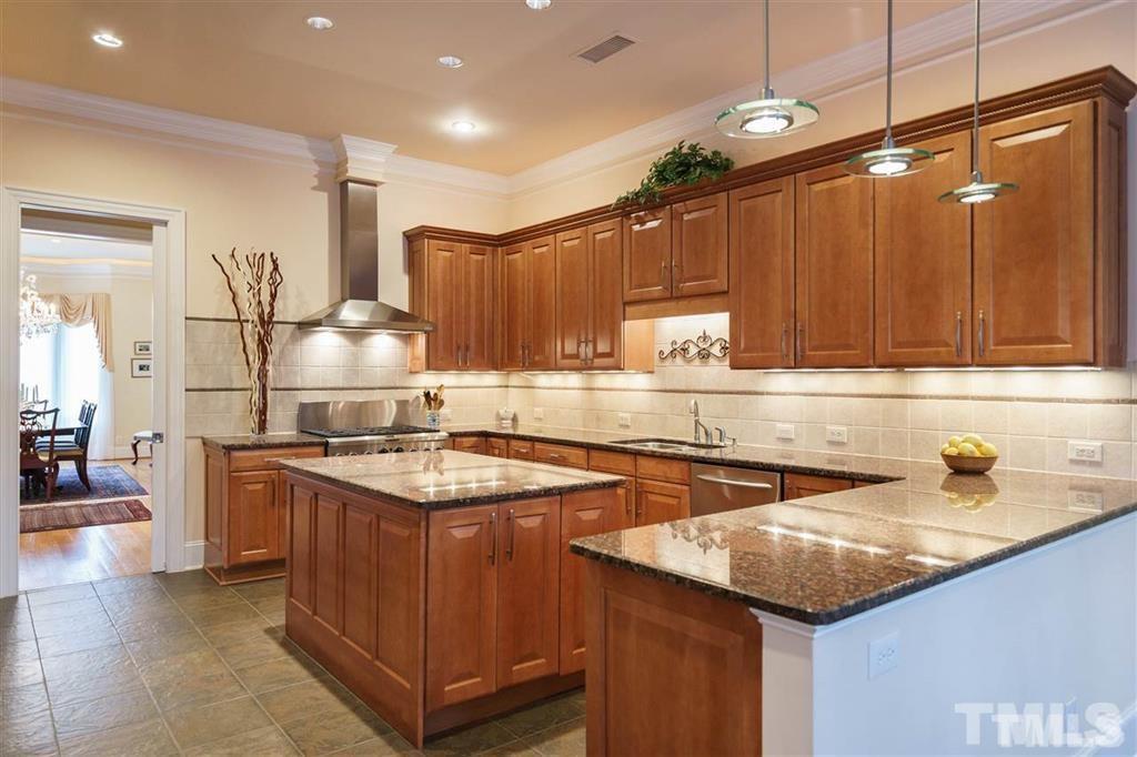 4008 Ovid Lane Raleigh, NC 27613 - Photo 10 of 25 a kitchen with a sink a stove and cabinets