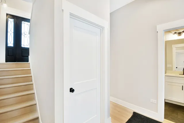 a view of a hallway with wooden floor and entryway