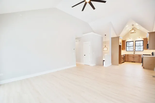 a view of a livingroom with a ceiling fan and window