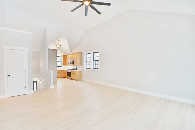 en empty room with ceiling fan and window