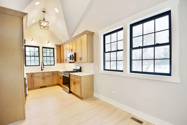 a large white kitchen with a large window