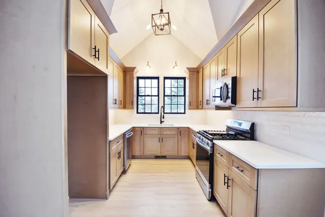 a kitchen with a sink stove and cabinets
