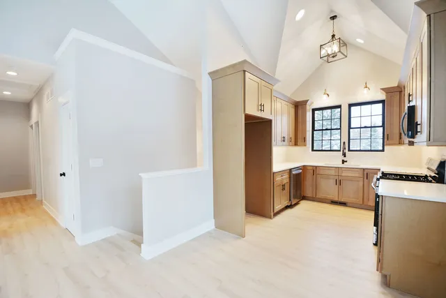a large white kitchen with cabinets and stainless steel appliances