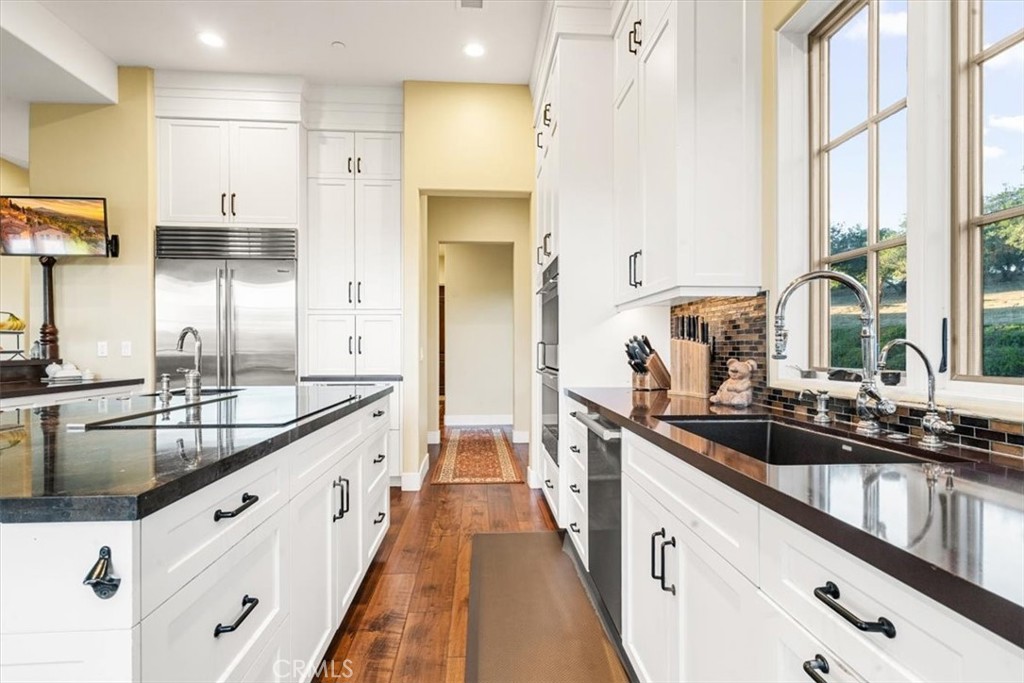 455 Mission Springs Road Arroyo Grande, CA 93420 - Photo 15 of 65 a large kitchen with granite countertop a sink and cabinets