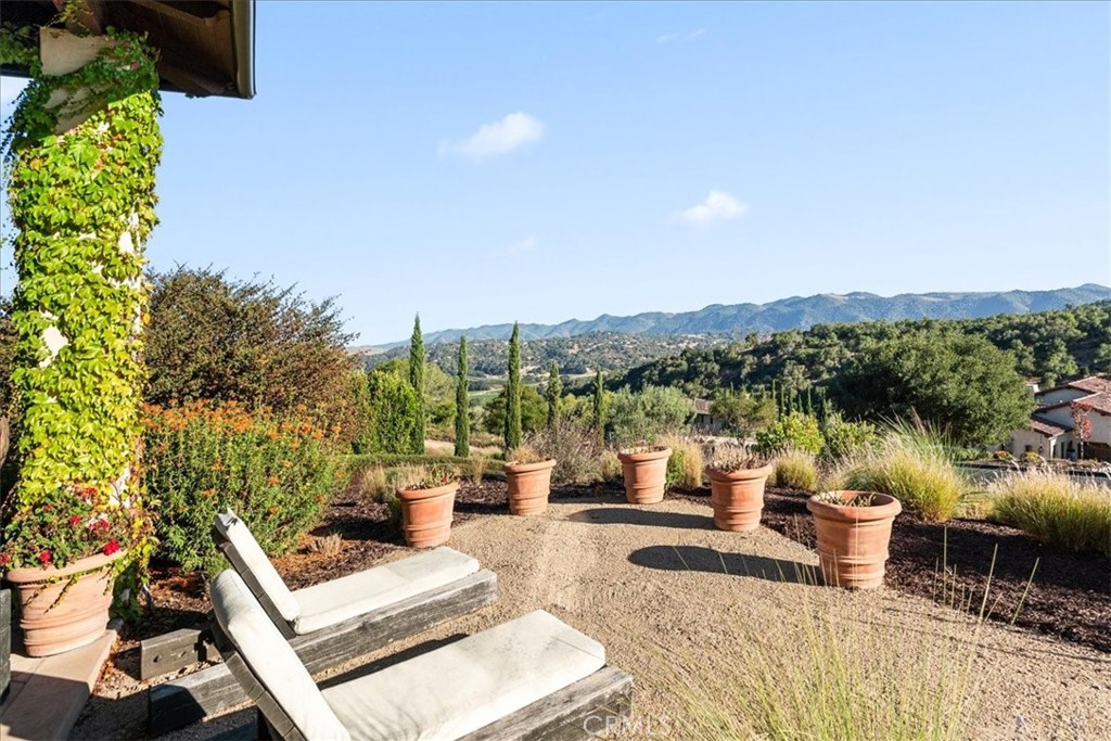 455 Mission Springs Road Arroyo Grande, CA 93420 - Photo 49 of 65 a view of a patio with couches table and chairs and potted plants