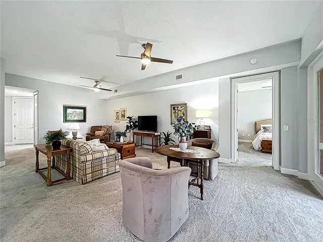 a view of a kitchen with kitchen island granite countertop a sink and a large window