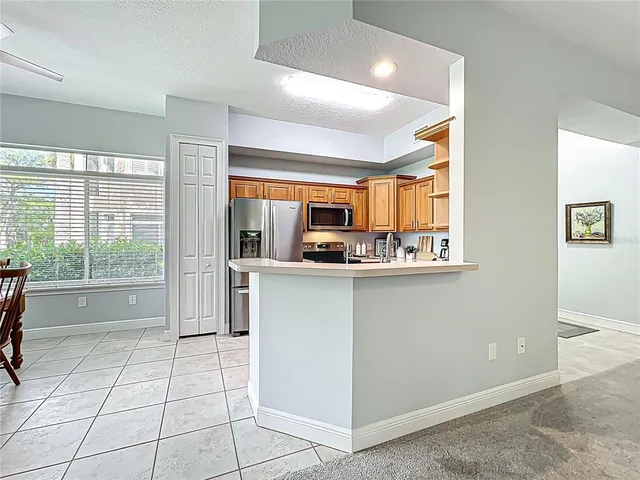 a view of a dining room and livingroom with furniture wooden floor and a chandelier