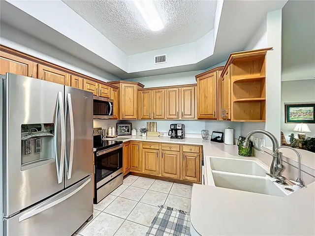 a view of a hallway with wooden floor and windows