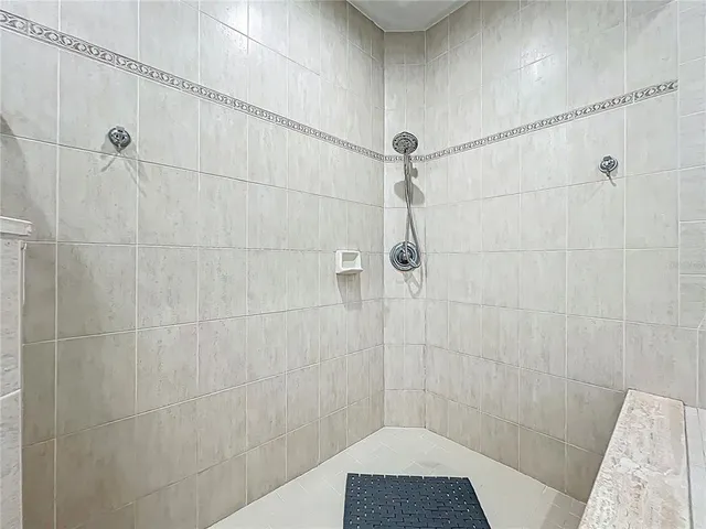 a view of a balcony with floor to ceiling window next to a yard