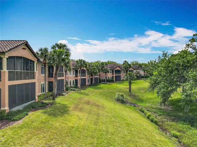 an aerial view of residential house with outdoor space and trees all around