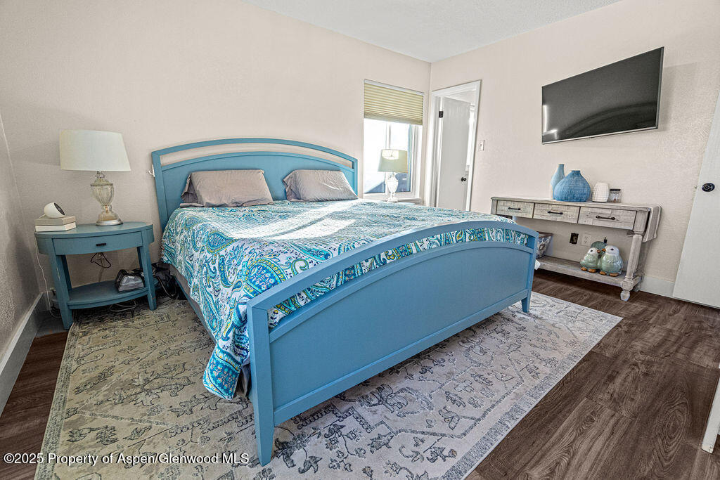 193 Barker Street Craig, CO 81625 - Photo 14 of 50 a bedroom with a bed and a flat screen tv