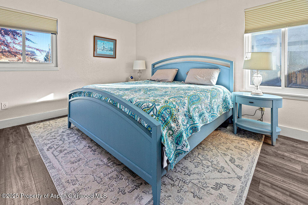 193 Barker Street Craig, CO 81625 - Photo 15 of 50 a bedroom with a bed rug and wooden floor