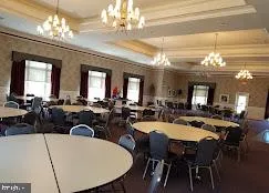 a view of a dining room with furniture and a chandelier