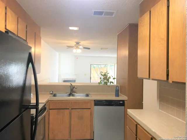 a kitchen with a sink and a refrigerator